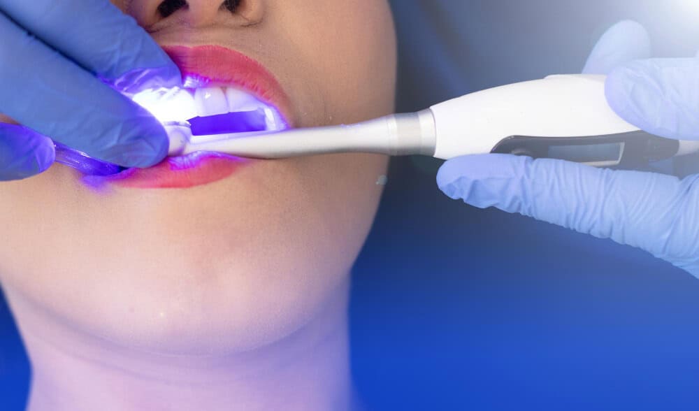 Dentist examining the patient’s teeth as part of the teeth whitening process in North Sydney