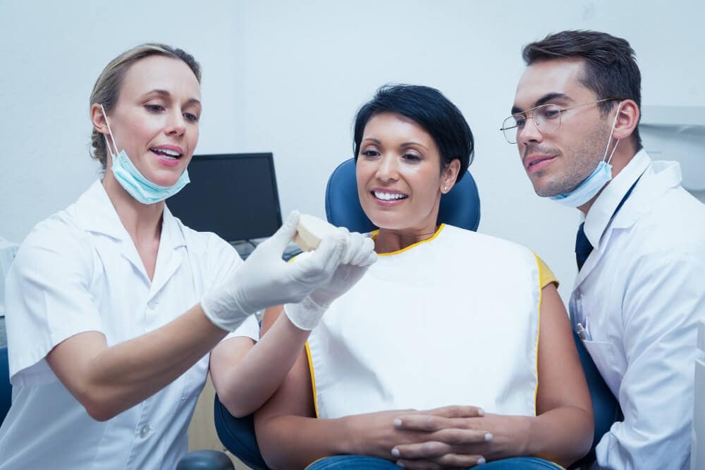 Dentist assessing teeth during smile makeover consultation in North Sydney