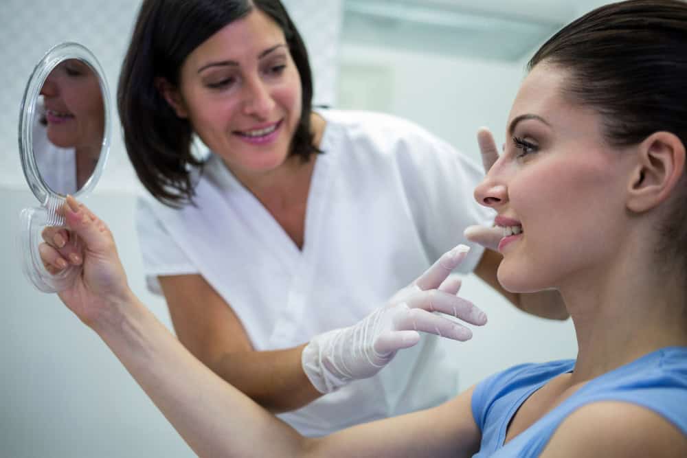 Patient examining results of cosmetic bonding in North Sydney dental clinic